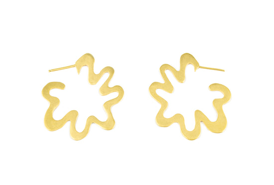 gold wavy hoop earrings laying side by side