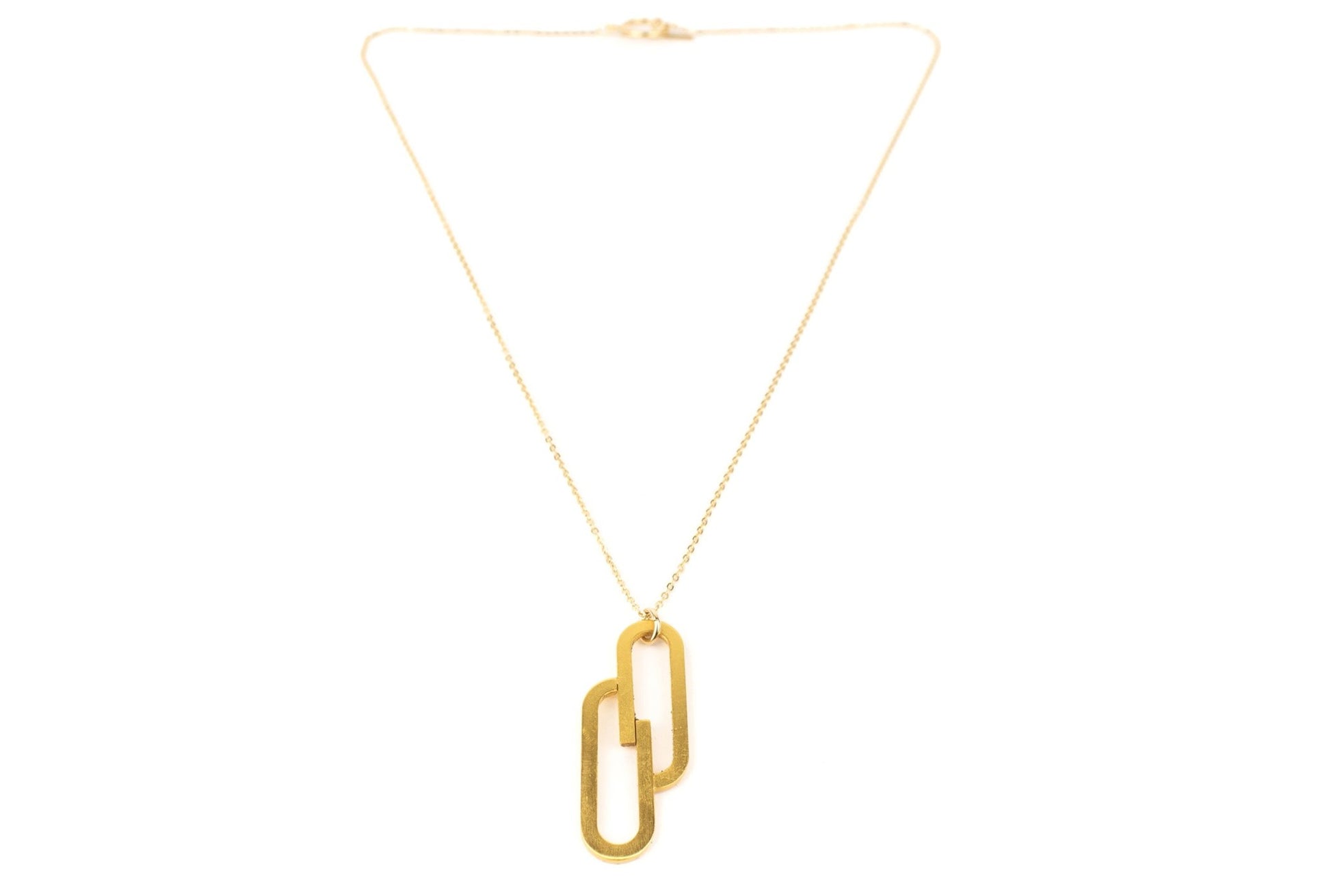 Gold Deco Charm Necklace with two gold wire ovals that intersect hanging on a fine gold chain on white background 